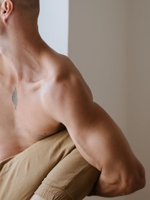 A focused man balancing during a core strength exercise.